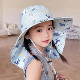 Child wearing a patterned sun hat indoors