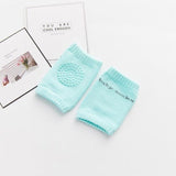 Pair of light blue baby socks on a white surface with text in the background.