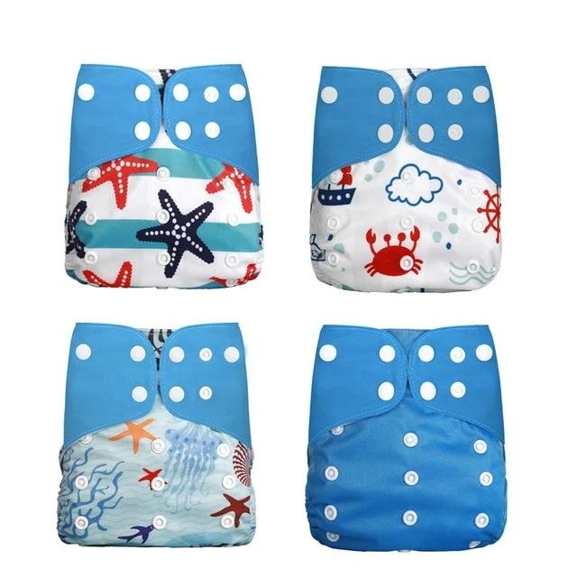 Four children's cloth diapers with ocean-themed prints 