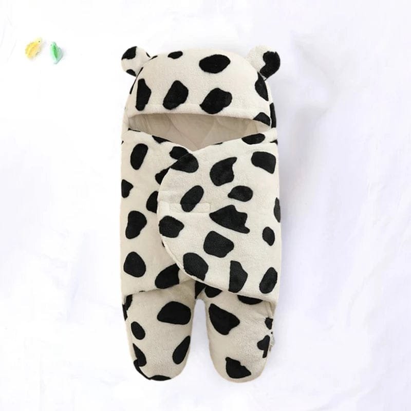 Cow print baby bunting on a white background