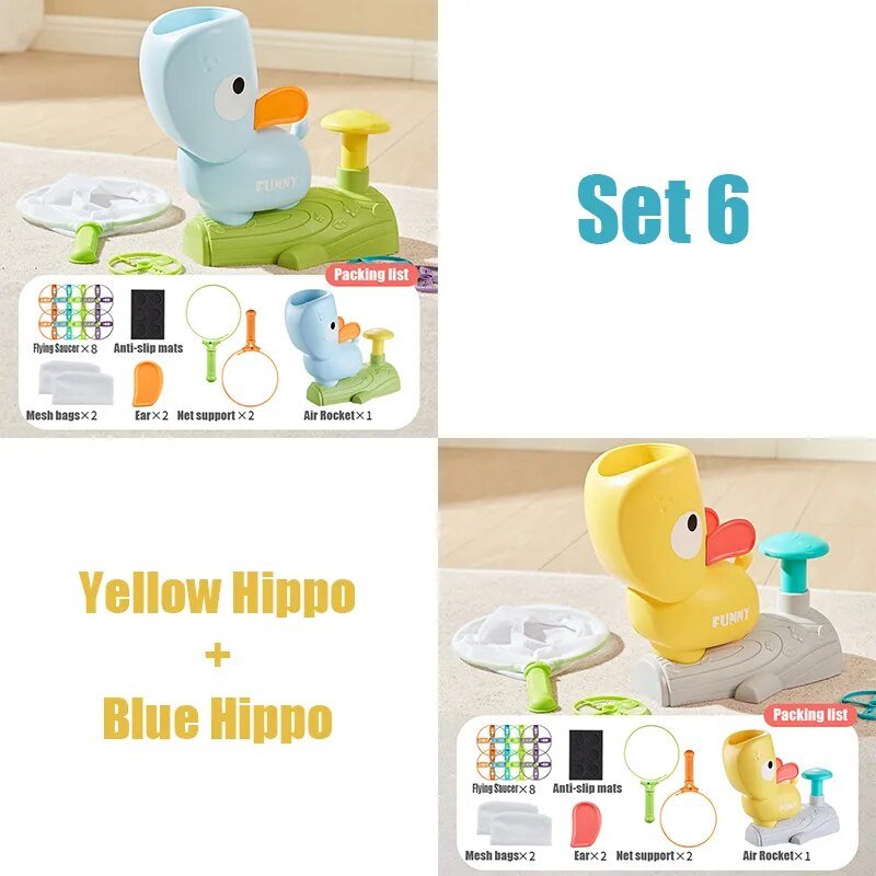 Two toy hippos, one yellow and one blue, with packaging and accessories 