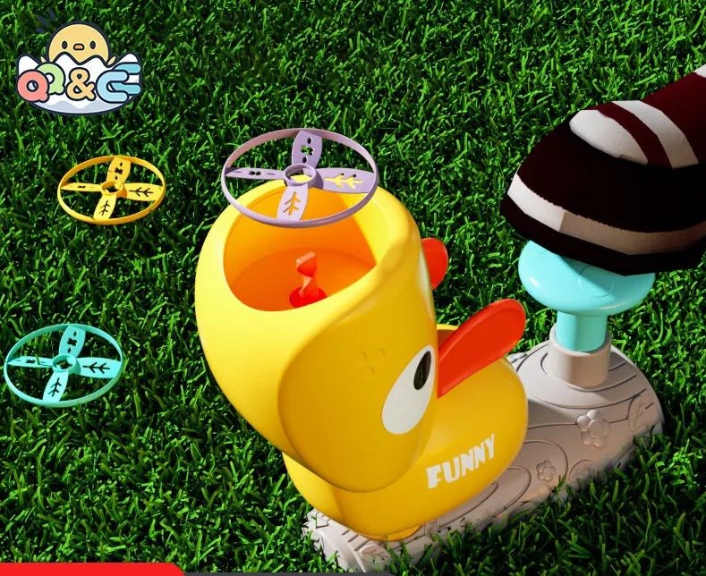 Toy duck with a propeller on grass, featuring the brand 'O&C'.