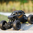 Toy off-road vehicle with large wheels on a gravel surface