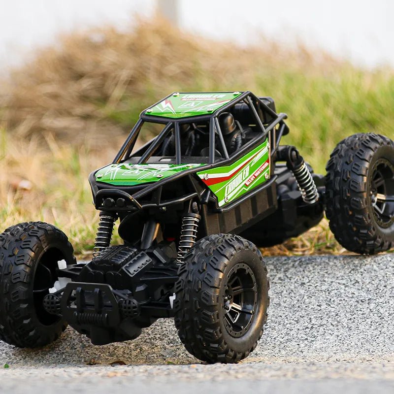 Green and black remote control off-road vehicle on a gravel surface 