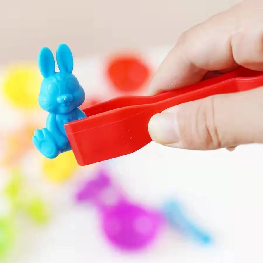 Hand holding a red tool with a blue rabbit.