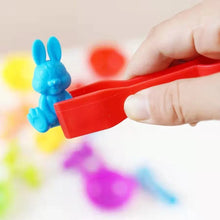 Hand holding a red tool with a blue rabbit.
