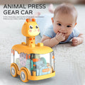 Yellow animal press gear car toy on a rug with a baby lying nearby