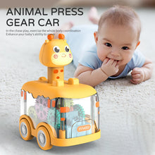 Yellow animal press gear car toy on a rug with a baby lying nearby