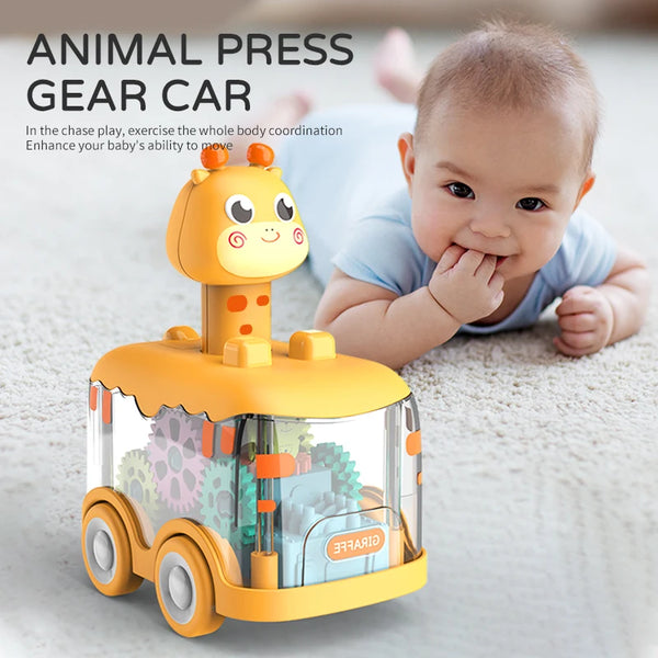 Yellow animal press gear car toy on a rug with a baby lying nearby