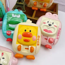 Yellow duck, pink rabbit and teal dinosaur slide puzzles standing on a shelf