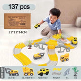 Child playing with a toy construction track set on a light-colored floor.
