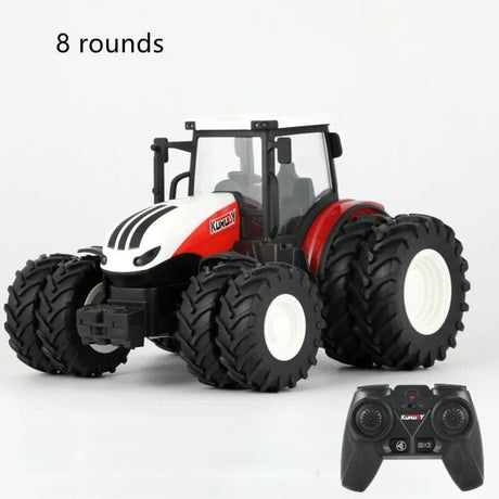 Toy tractor with large wheels and a remote control on a white background