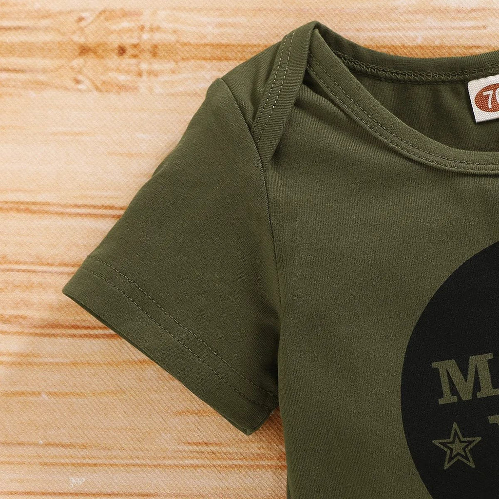 Green t-shirt with a logo on a wooden surface