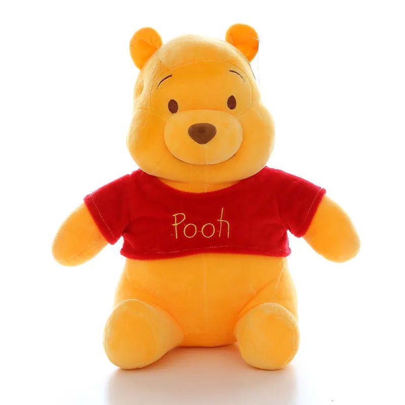 Plush toy bear wearing a red shirt with 'Pooh' on it against a white background