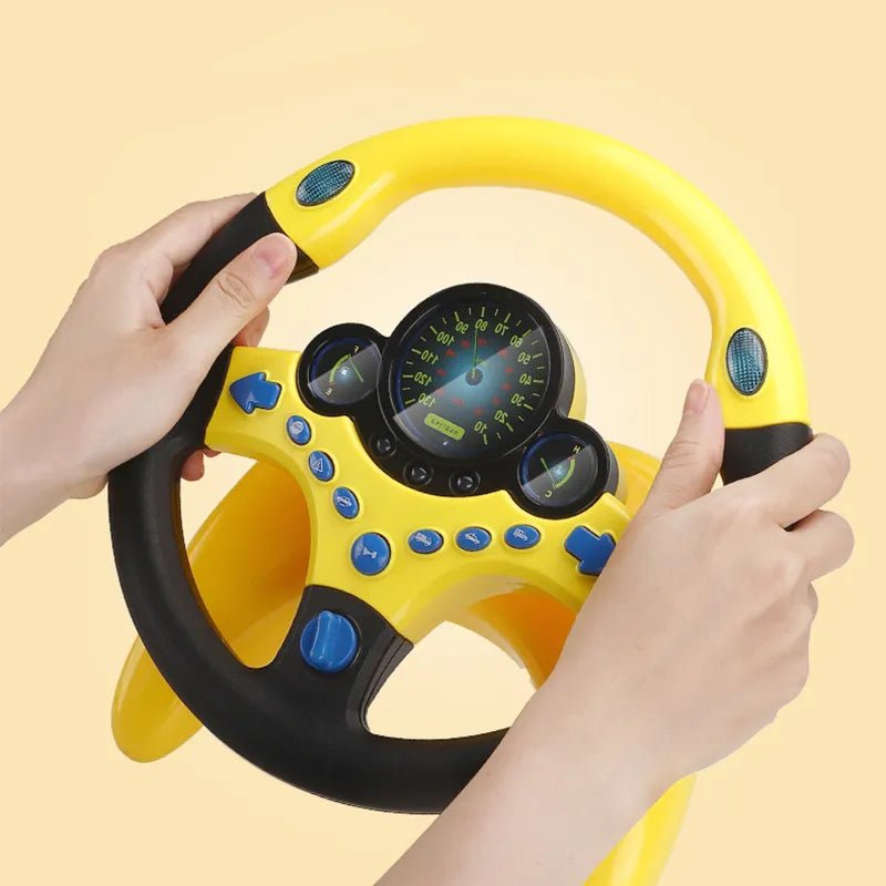 Yellow toy steering wheel with blue buttons held by two hands on a beige background