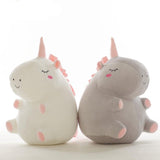 Two plush toys resembling unicorns.