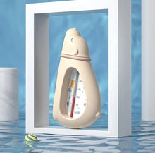Baby Bath Thermometer bottle-shaped float used in a filled tub for safe water temperature checks before bathing.