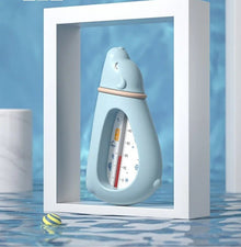 Baby Bath Thermometer in a bottle shape floating in water for easy temperature reading during newborn bathing.