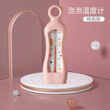 Baby Bath Thermometer pink bubble float with a round dial for quick temperature reading before lowering baby in.