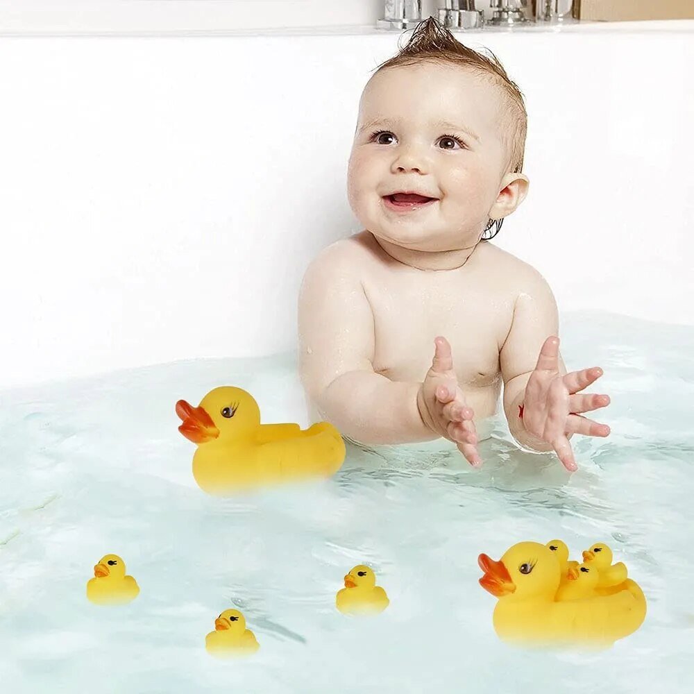 Baby playing with the rubber duck family in the tub, squeaky bath toys that make washing and hair rinsing easier for toddlers.