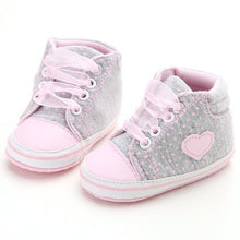 Pair of baby shoes with pink hearts 