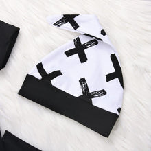 Patterned baby hat from the black and white three-piece boy set for nursery days and outdoor outings.