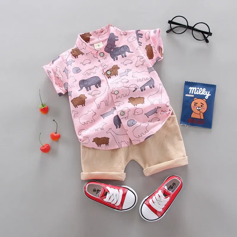 Children's outfit with pink shirt and shorts, red sneakers, and small items