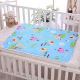 Colorful cartoon-patterned mat on a white crib with a plush toy.