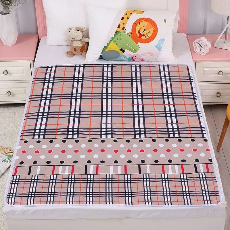 Plaid and polka dot blanket on a bed with cartoon pillow