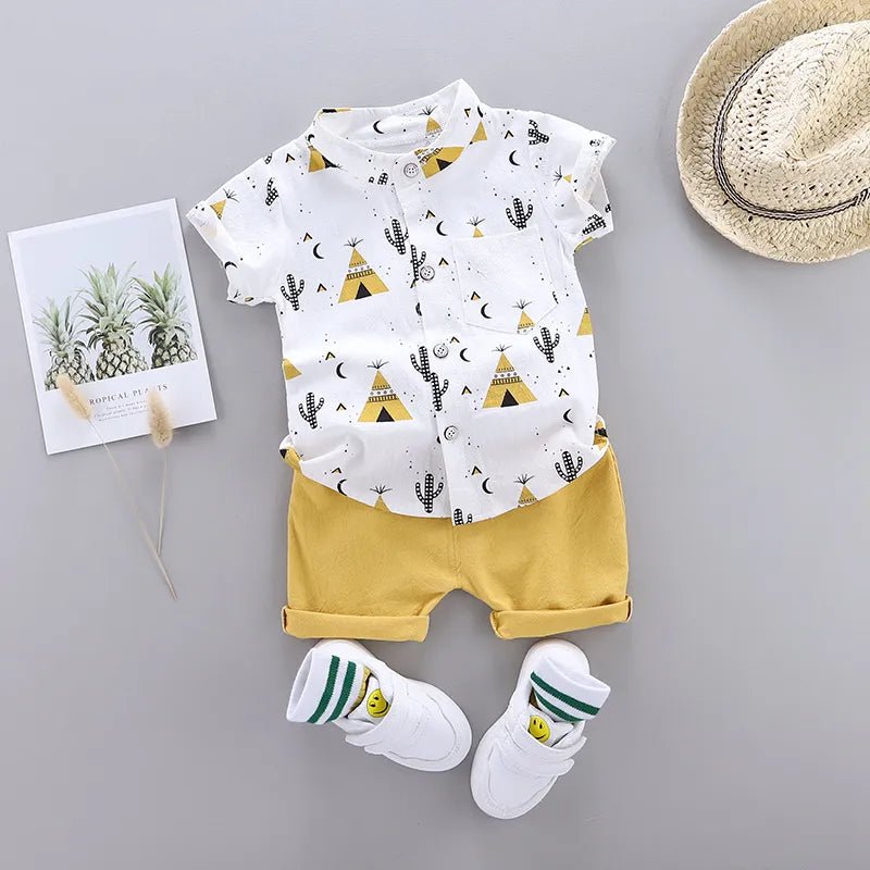 Baby outfit with white shirt and yellow shorts, white socks, and a straw hat 