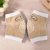 Pair of beige baby socks with white accents.