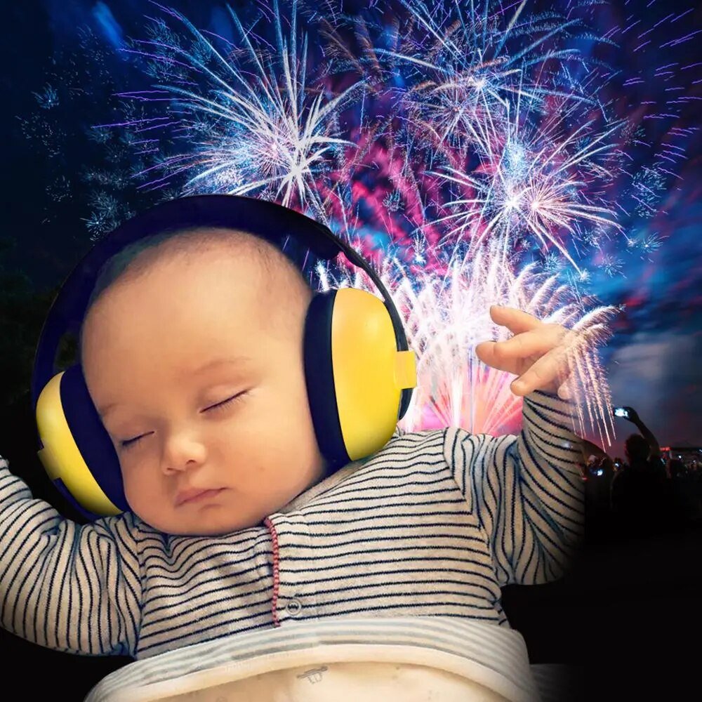 Baby wearing anti-noise earmuffs during fireworks for safe hearing protection outdoors.