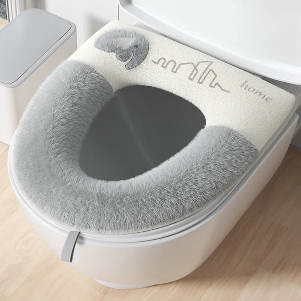 Baby Elephant Plush Toilet Seat Cover in grey fitted on a toilet lid for warm, comfortable family bathroom use.