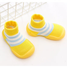 Pair of yellow baby shoes with blue stripes 