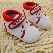 White baby shoes with red accents 