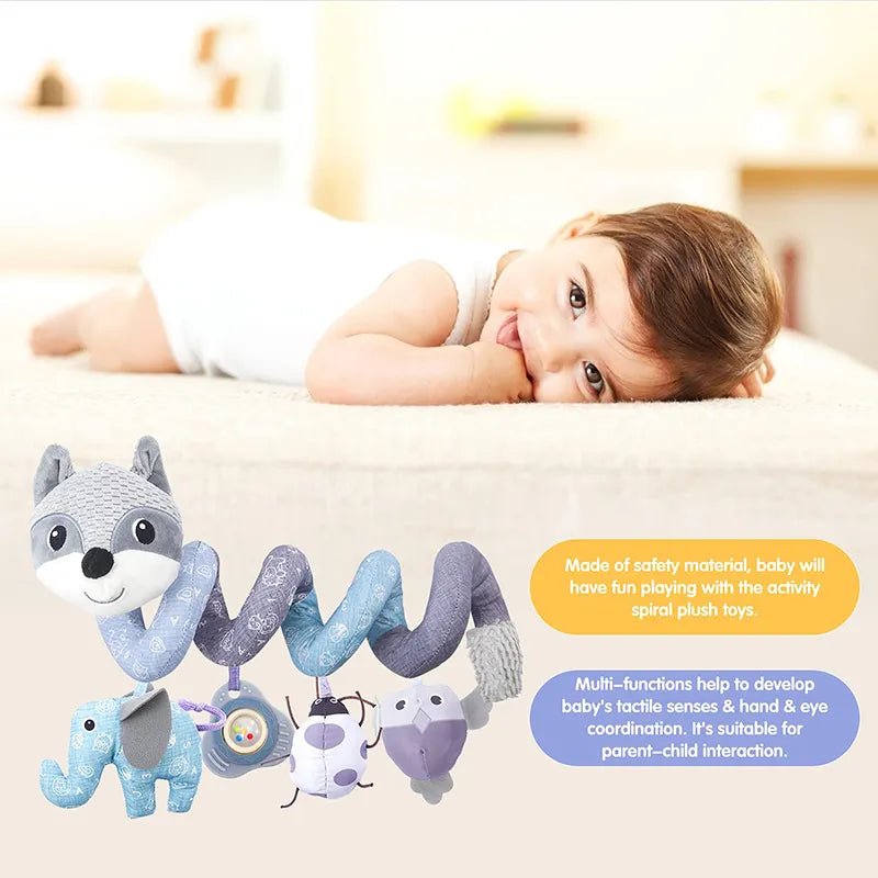 Baby lying on the bed with fox spiral plush toys featuring animal designs and music.