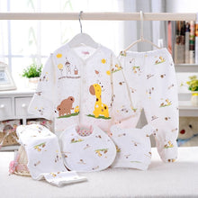 Baby girl cartoon print newborn outfit set hanging indoors, a spring summer clothing bundle for warm-weather dressing.