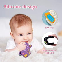 Baby holding a remote control shape teether toy for safe chewing, gum relief, and hand grip practice.