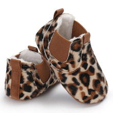 Pair of leopard print baby shoes with brown accents.