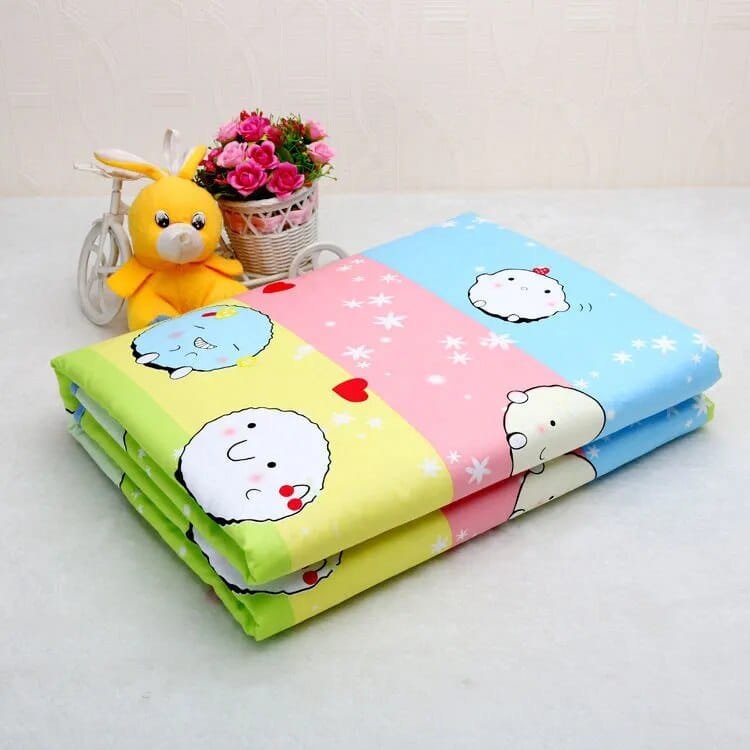 Colorful cartoon-patterned blanket with a plush toy and flowers on a light background