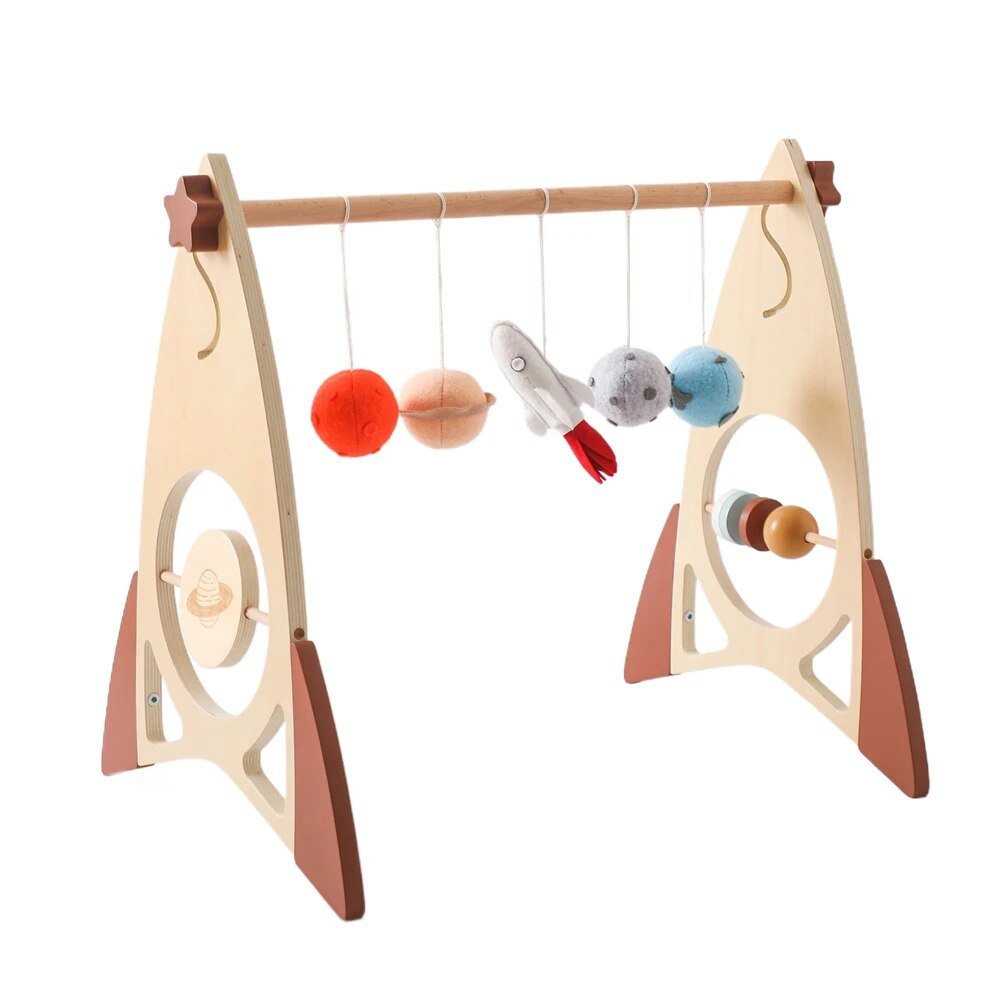 Angled view of the wooden baby play gym frame with hanging mobile toys for everyday nursery playtime.