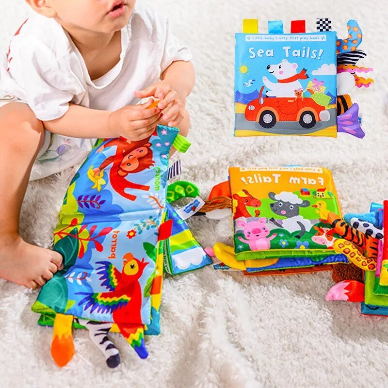 Baby playing with colorful animal tail cloth books on a soft surface for tummy time.