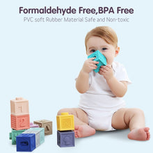 Baby playing with soft rubber grasp blocks for bath time fun and safe sensory exploration.