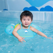 Baby seated in the pool swimming ring float for supported paddling during family swim sessions.
