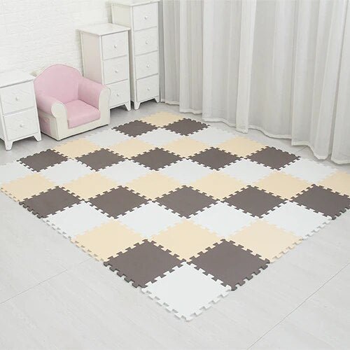Checkered foam puzzle mat on a tiled floor with white furniture and curtains.