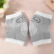 Grey dotted baby knee pads for crawling across carpets and smooth floors without knee rubs or scrapes.