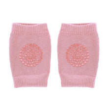 Pink knitted baby knee pads with textured finish to protect delicate knees while learning to crawl.
