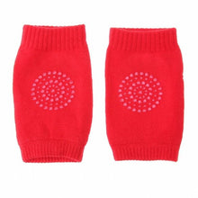 Red knitted non-slip toddler knee pads for home use on wooden floors, rugs, and play mats.