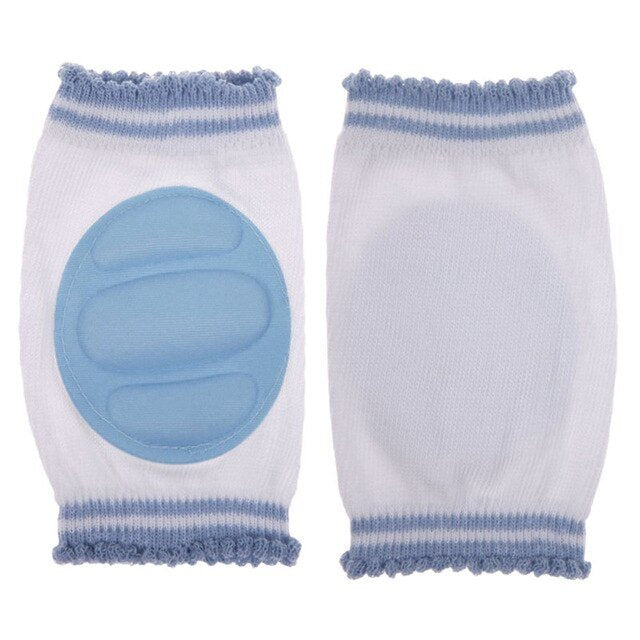 White knee pads with blue padded trim for comfortable infant daily use during tummy time and crawling.