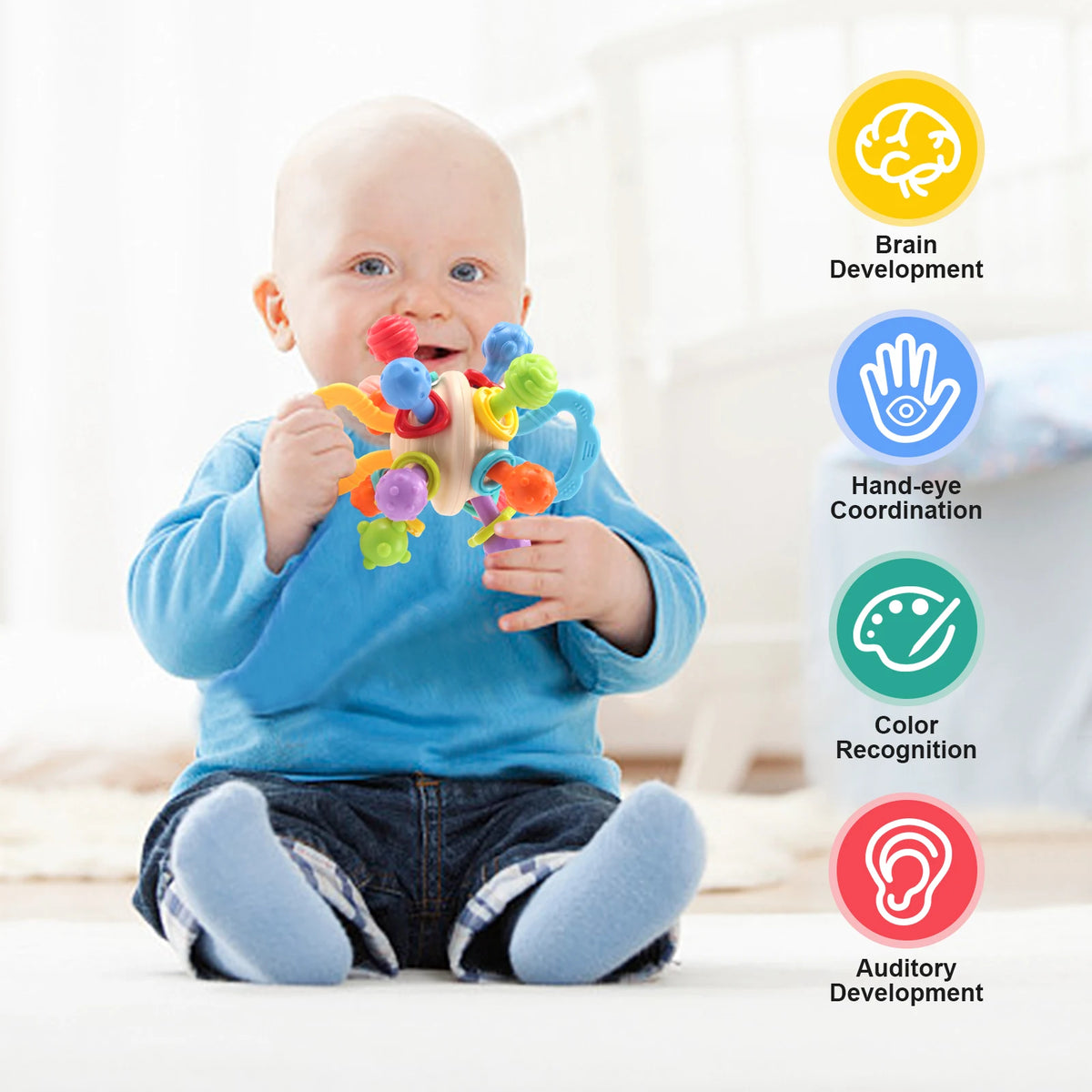 Baby sitting and chewing on a colorful sensory rattle teether ball